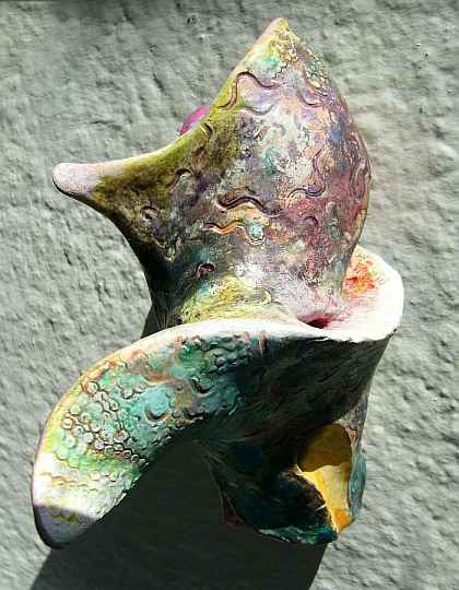 Abstract ceramic sculpture with spiral finlike shapes.  Click to enlarge.