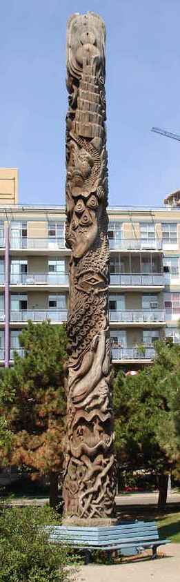 A dream-inspired totem pole on the Toronto waterfont by Georganna Malloff, showing people and whales.