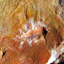 An Uluru-type rock rising 4 km from the plains of Io, sculpted by Chris Wayan