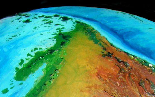 Low-altitude orbital shot looking west at western Ara (desert below and on right, savanna and monsoon forest on left, green islands on horizon) on Kakalea, a model of an Earthlike world full of Australias.