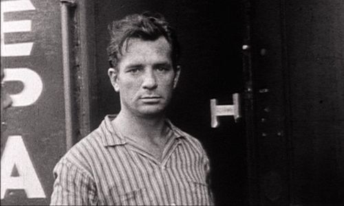 photo of writer Jack Kerouac by a train.